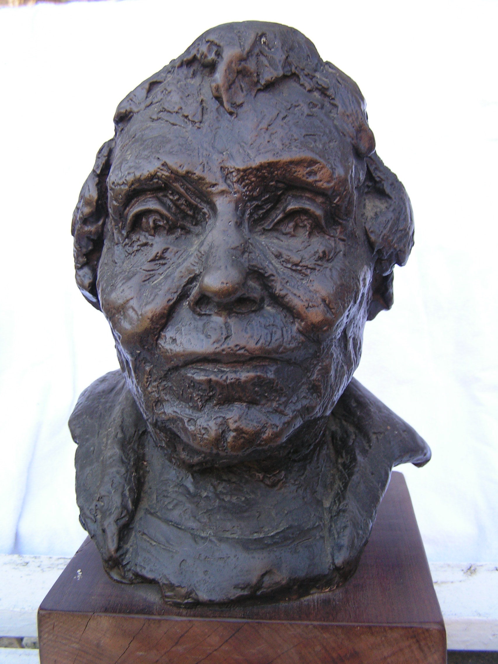 A bronze bust of Violetta Thurstan in her later life, with short hair.