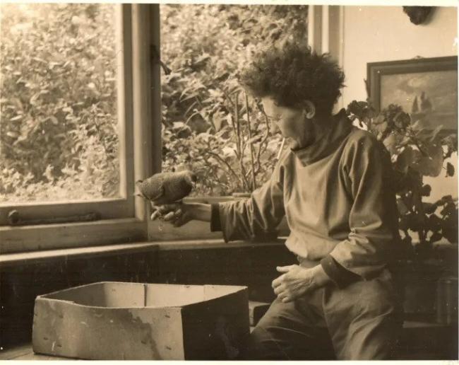 A photograph of Phyllis Yglesias with a pigeon perched on her finger.